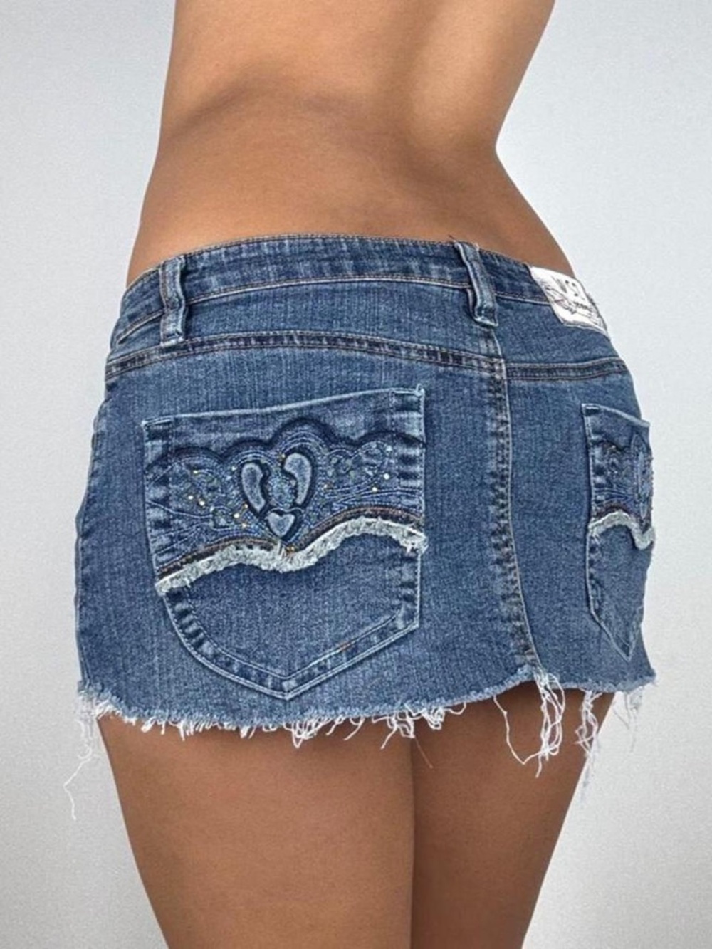 Y2K blue denim mini skirt with heart embroidery on back pocket